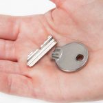 The broken house key in hand.